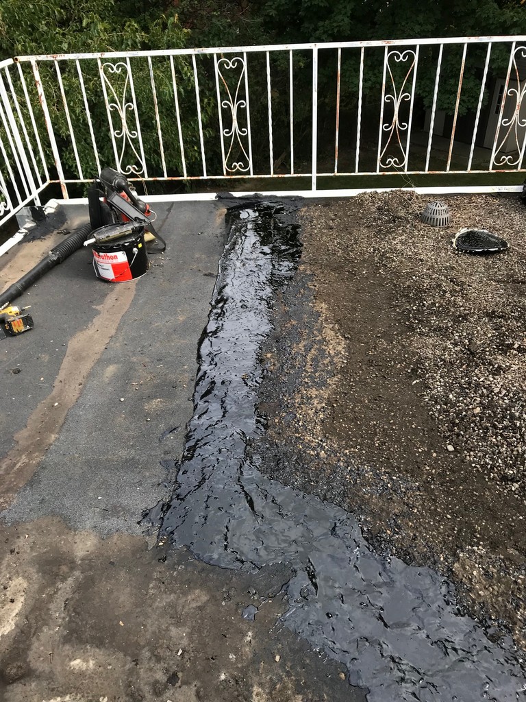 Strategic flat roof repairs on tar and gravel roof in ...