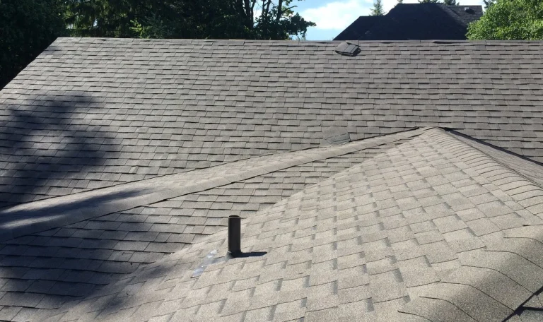 Asphalt shingle roof on a residential home with a plumbing vent and roof vent