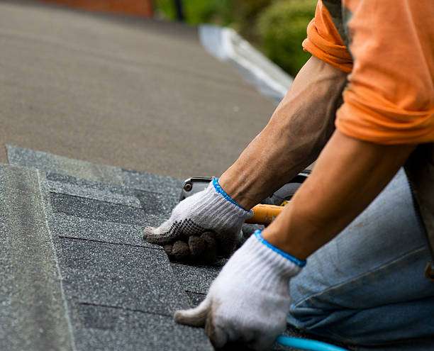 Professional roofer installing asphalt shingles on a residential roof in Ajax
