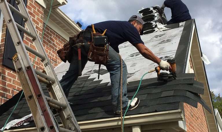 Metro Roofing technician using a nail gun during roof installation in Ajax