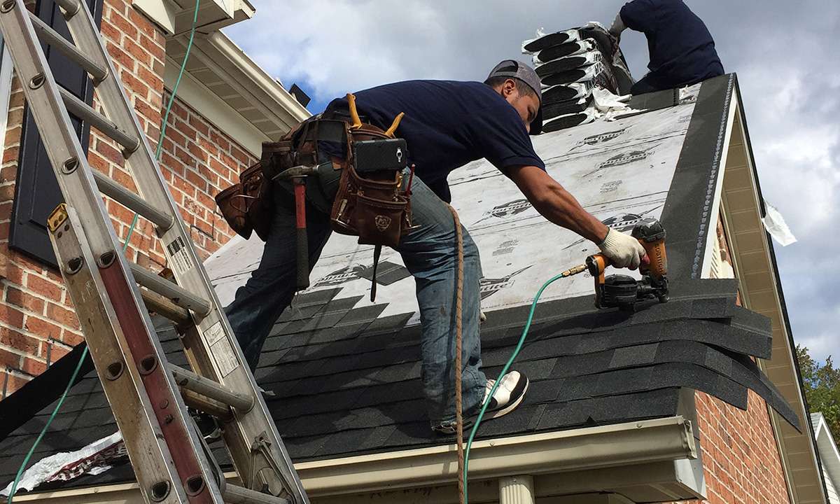 Metro Roofing technician using a nail gun during roof installation in Ajax